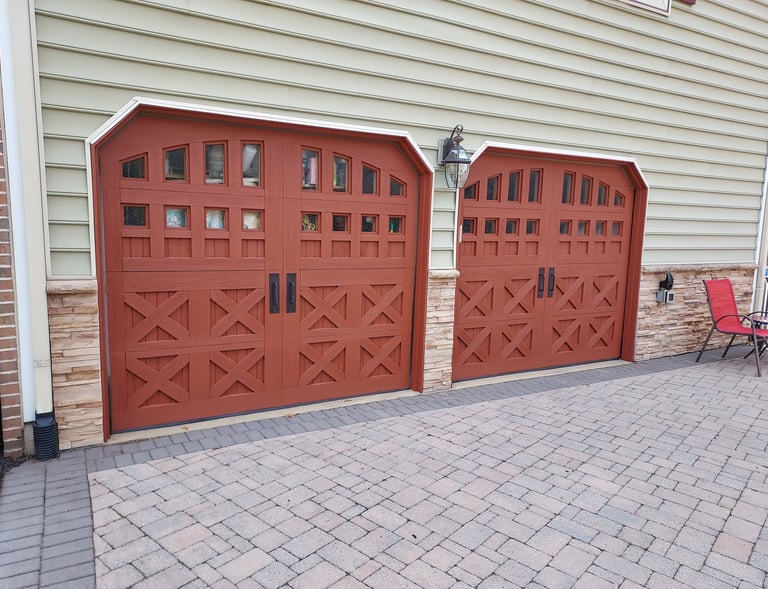  a drive way with 2 painted garage doors
