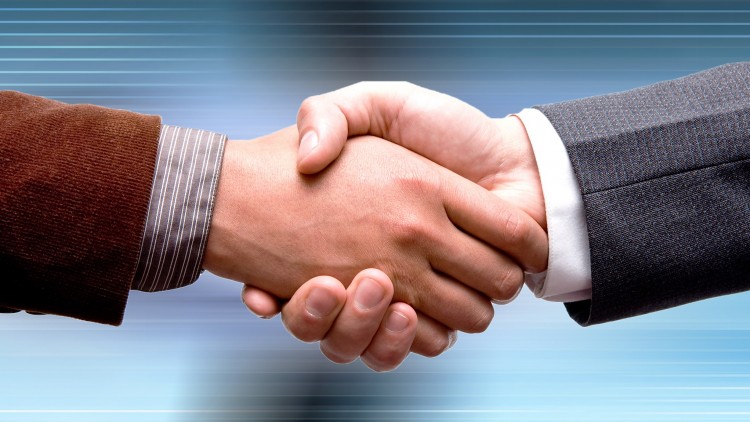 two people shaking hands with a blue sky in the background