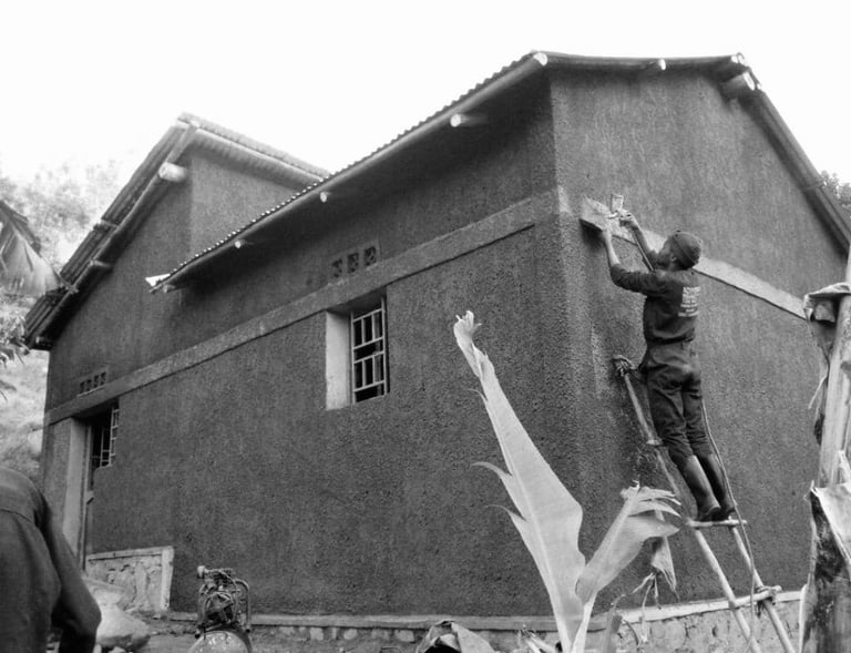 black and white photo of team building a new home in rwanda