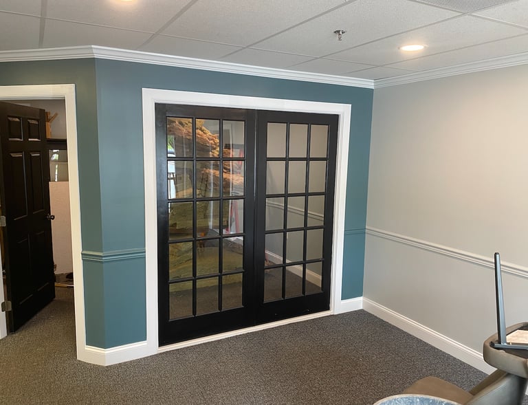 a living room with a couch and a television and a fresh paint job