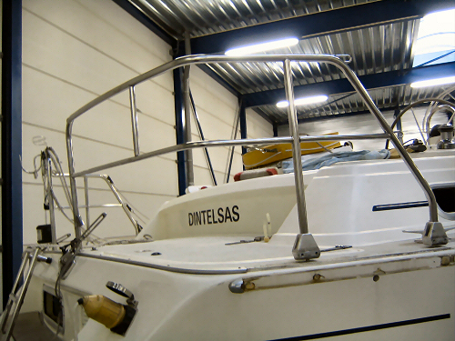 a boat in a warehouse with a metal railing
