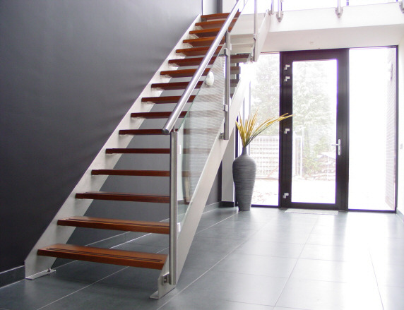 a staircase with a metal and glass railing
