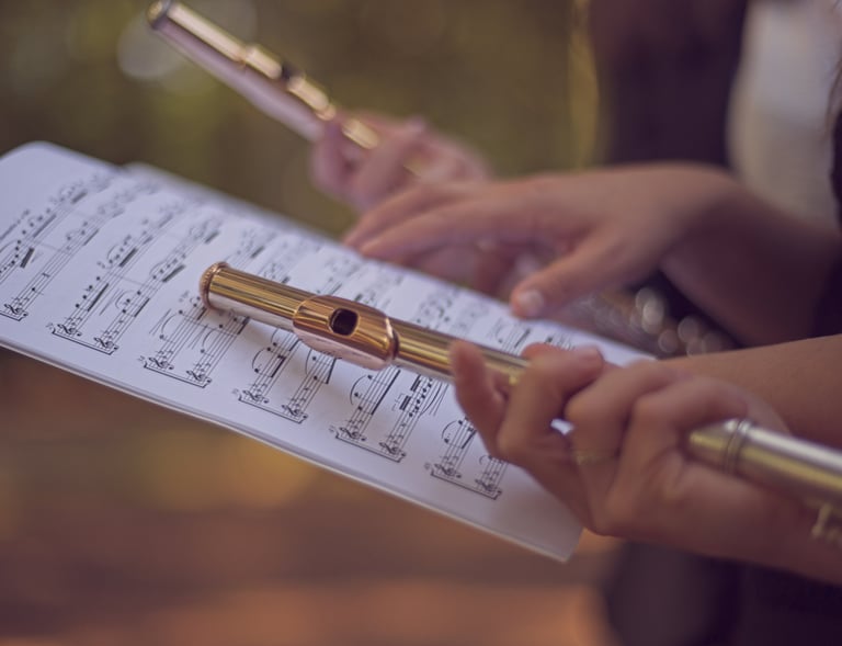 three women sitting on a bench in a park
