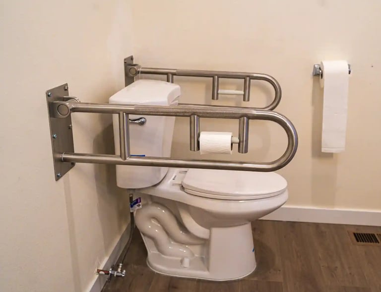 Accessible washroom in adult family home with grab bars, sink, and non-slip flooring.