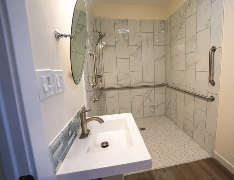 Adult Family Home bathroom with grab bars, and slip-resistant tile flooring