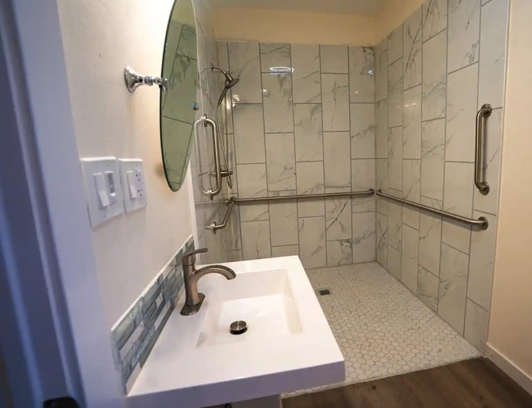 Adult Family Home bathroom with grab bars, and slip-resistant tile flooring