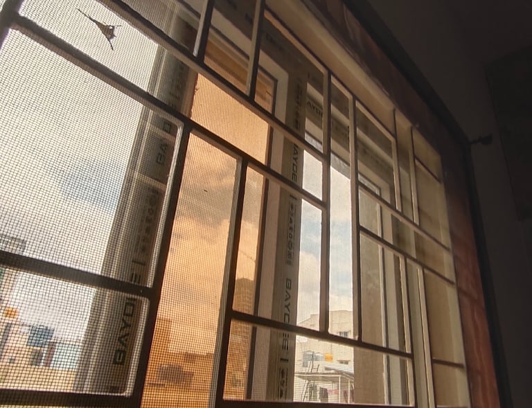 Close-up of a velcro mosquito net neatly fitted on a balcony door in Bangalore.