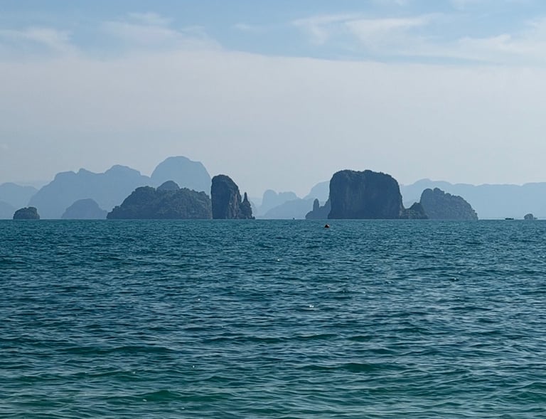 Scenic ocean view of limestone islands near Phuket coastline