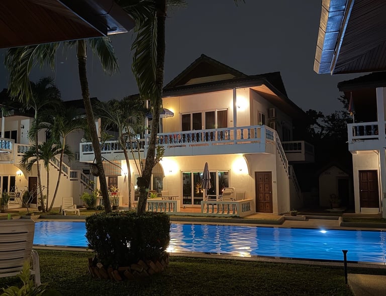 Illuminated swimming pool at night at Yanui Apartments Phuket villa rental