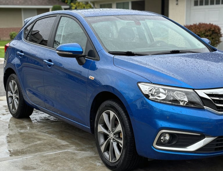 Close-up of a technician carefully cleaning a car dashboard with detailed precision.