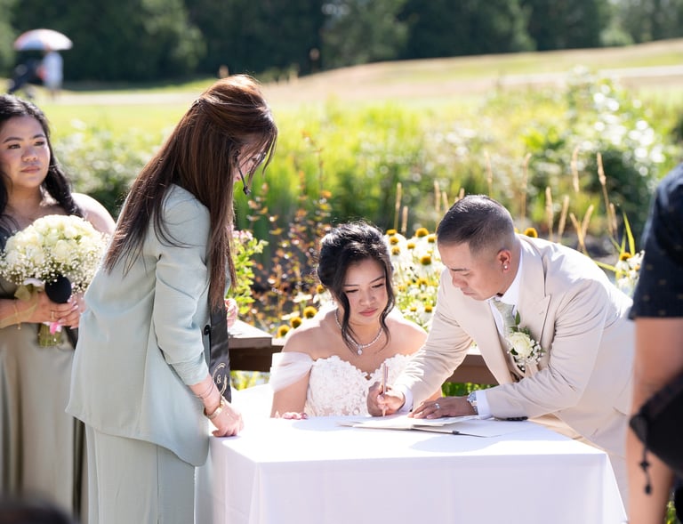 man and woman signing document 