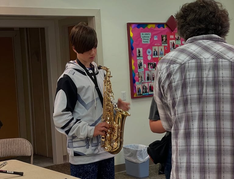 TAHB student checks out what the sax feels like