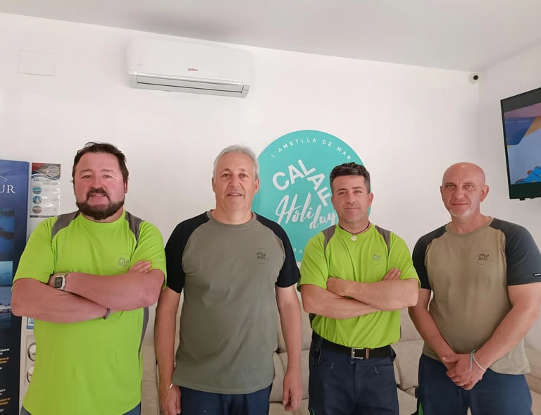 a group of men standing in front of a television