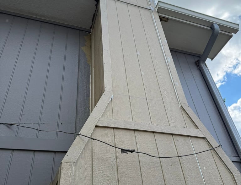 Close-up of a vinyl siding patch repair in Omaha, NE, showing a seamless color match on a residentia