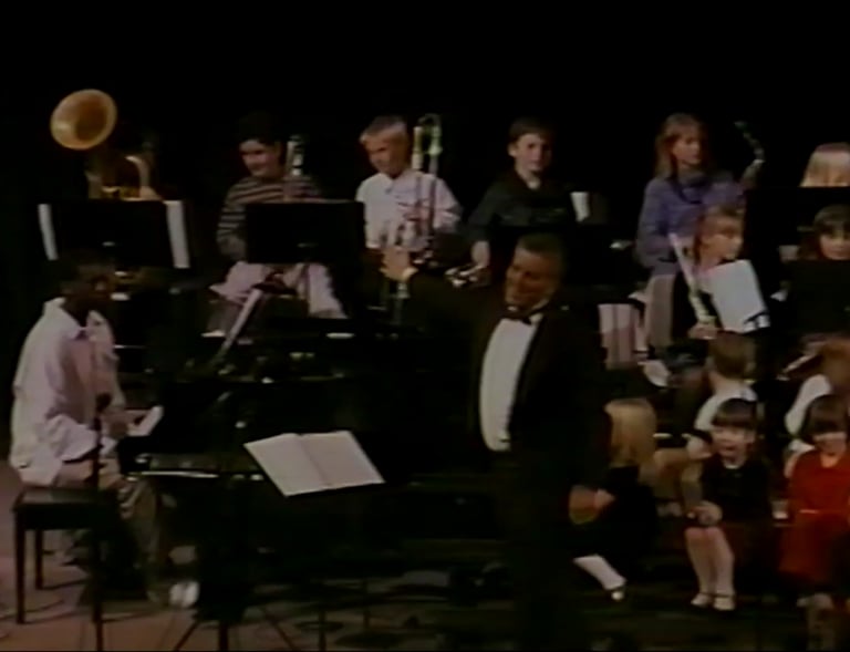 The kindergartners wait patiently as the beginning band (fifth grade) finishes their performance.