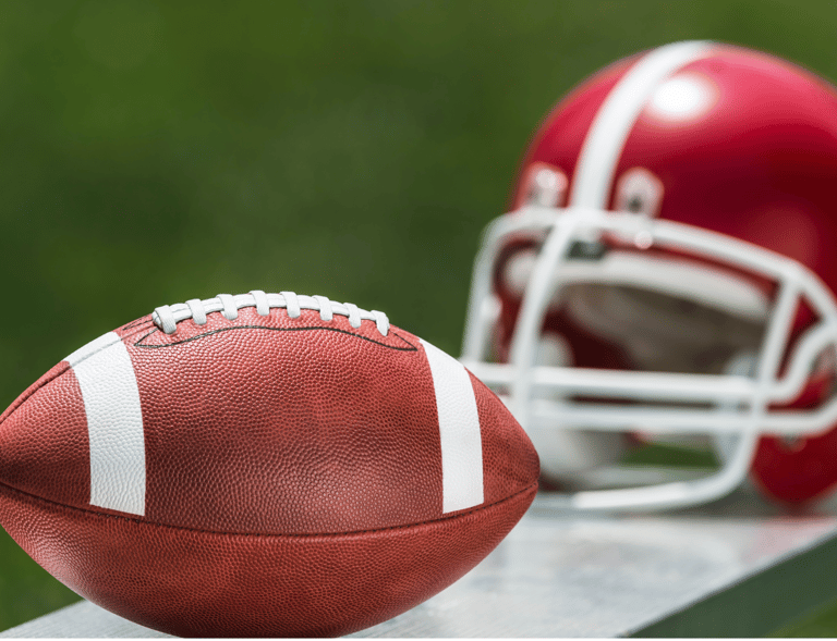 a football helmet and a football ball on a bench