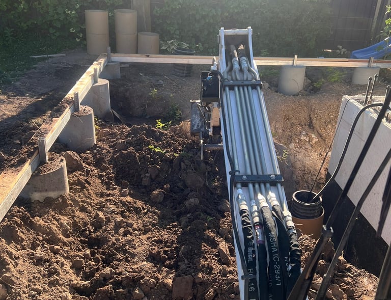 Excavator digging to build a retaining wall