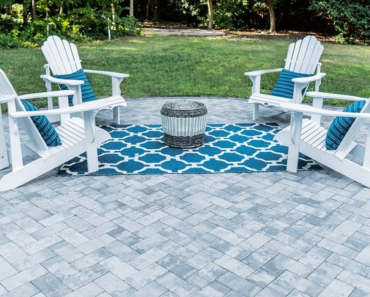 a patio with white chairs 