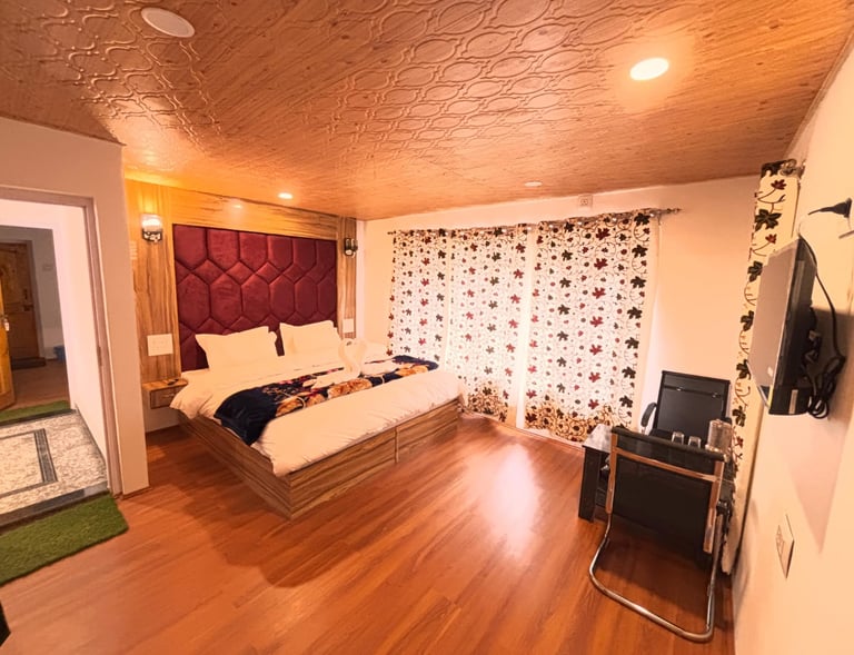 A warm room in Kashmir with rich embroidered curtains, a low seating area