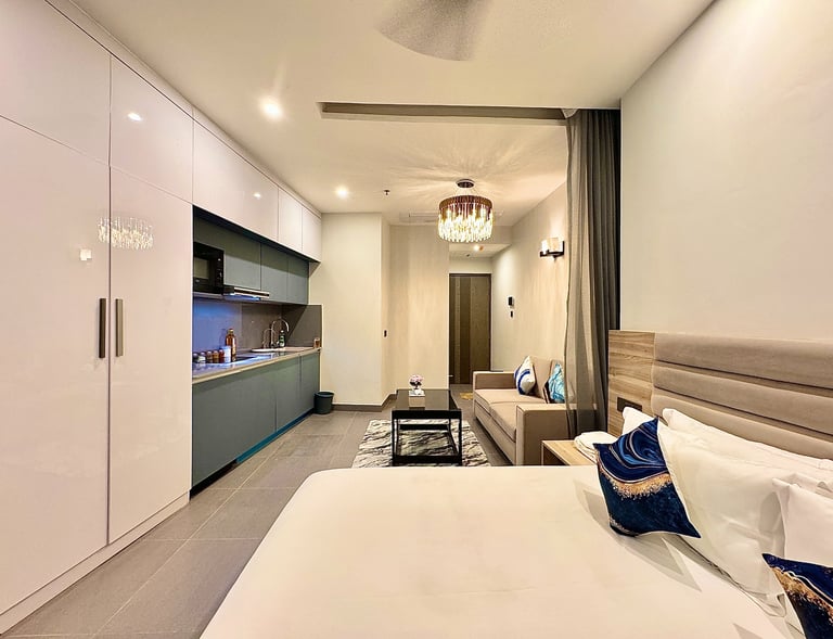 Luxury bedroom with a bed, couch, and kitchen