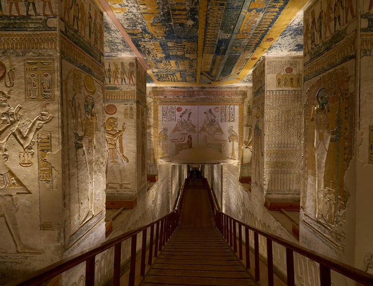 Ancient Egyptian temple corridor with wall carvings and a wooden walkway.