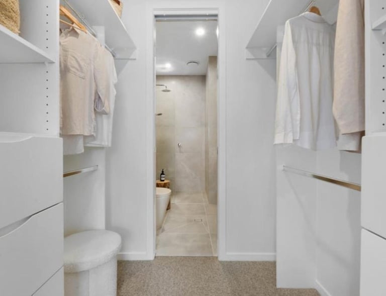 walk in wardrobe through to two basin bathroom