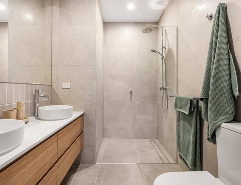 a bathroom with a toilet and a sink rainwater shower two basin luxury ensuite
