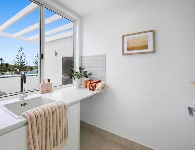 a laundry with a view at Arvia Villa Koala Park with a sink and a window