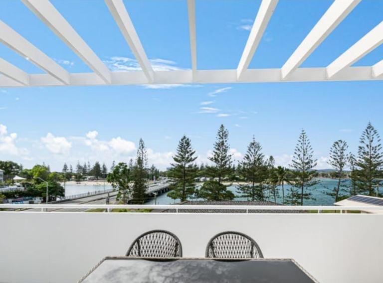 a table with a table and chairs on a balcony private terrace and barbecue overlooking tallebudgera c