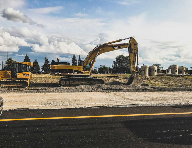 a construction site with a bulldozer and a truck