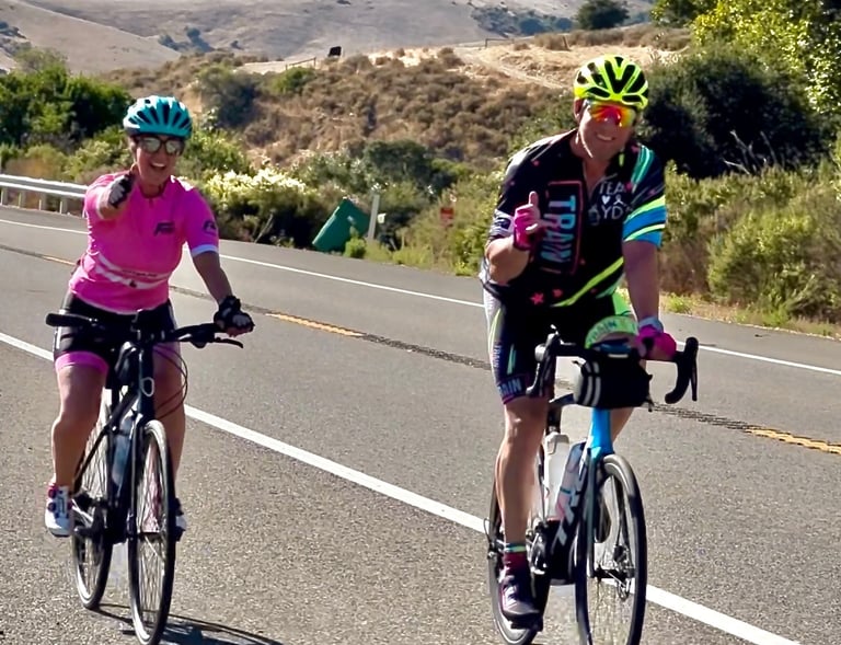 A man and a woman cycling in the outdoors