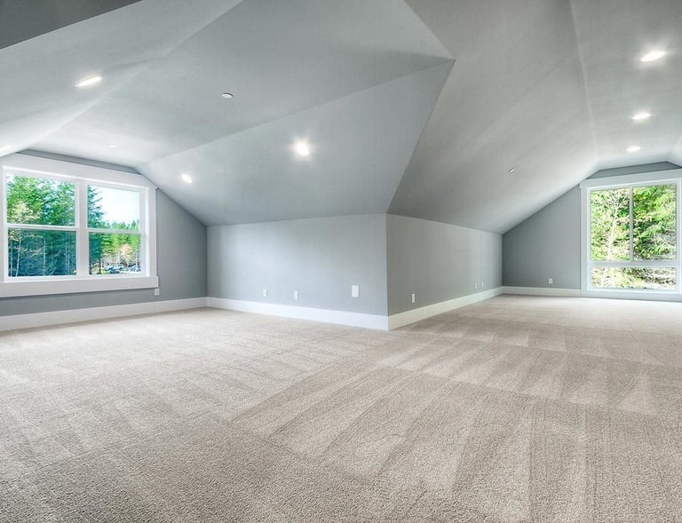 Freshly vacuumed carpeted attic space with natural light – SparkEaseCleaning 