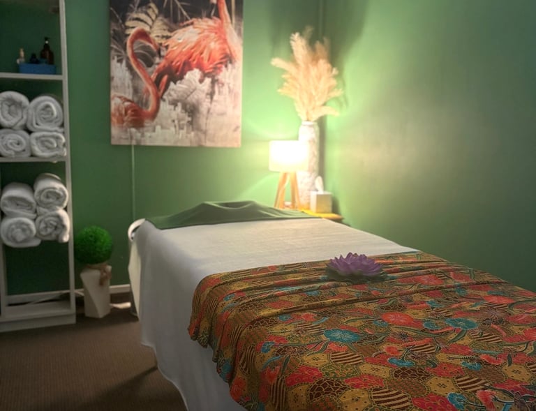 Tranquil Thai-style massage room at Ashburton Thai Massage & Spa with soft lighting, comfortable massage bed, and traditional
