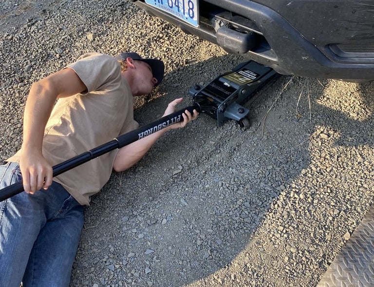 Elias jacking up a car