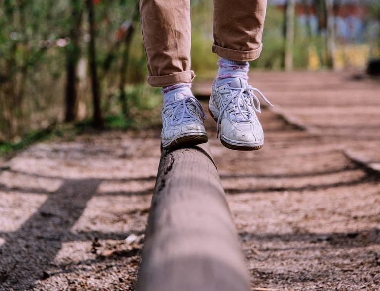 kid walking a fine line trying not to fall