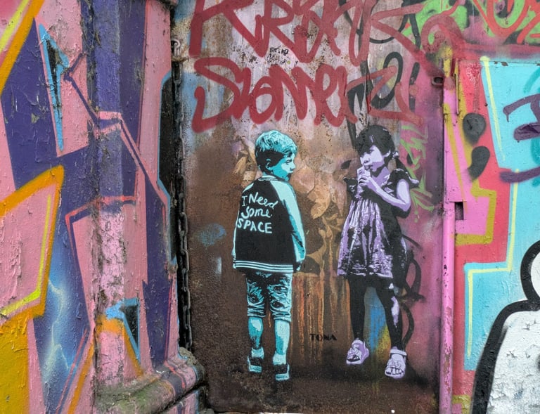 Street art at Rote Flora Hamburg with children stencil graffiti, urbane Kunst und Graffiti Szene in St. Pauli