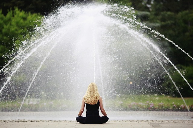 woman sitting in rain representing spiritual cleansing 