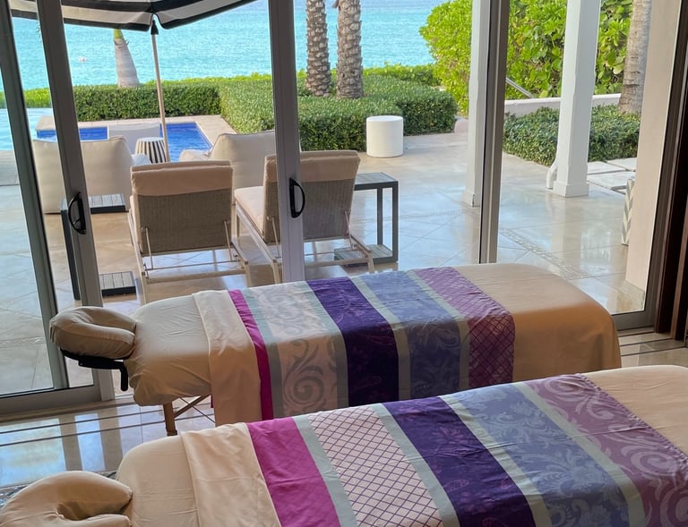 two massages by sophia massage beds in a room with a view of the ocean