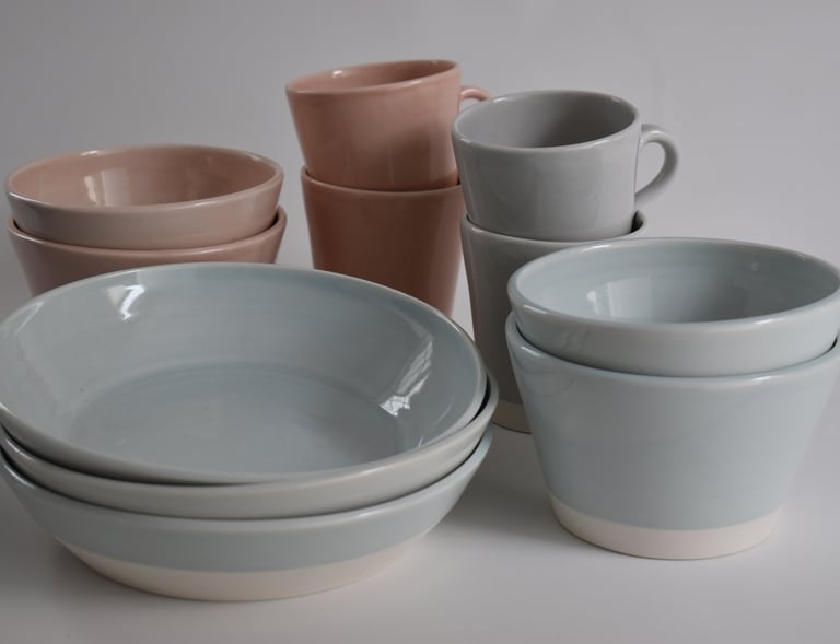 Breakfast and Small bowls in Duck Egg Blue and Pale Pink. Mugs in Pale Pink and Pale Grey
