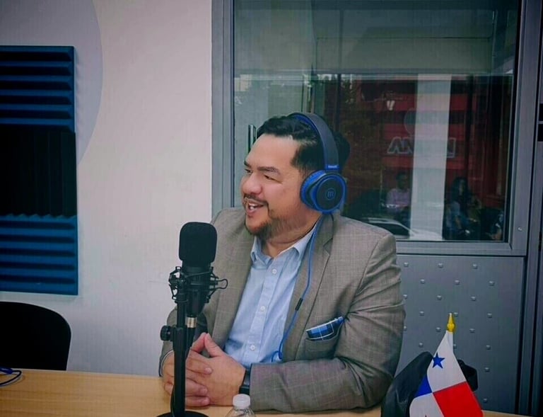 hector villamil with headphones on a microphone
