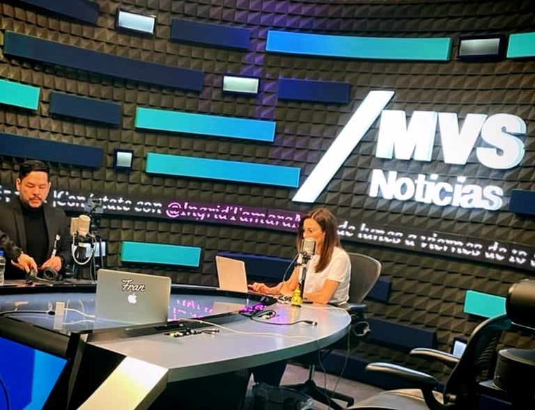 a man and woman sitting at a table with laptops