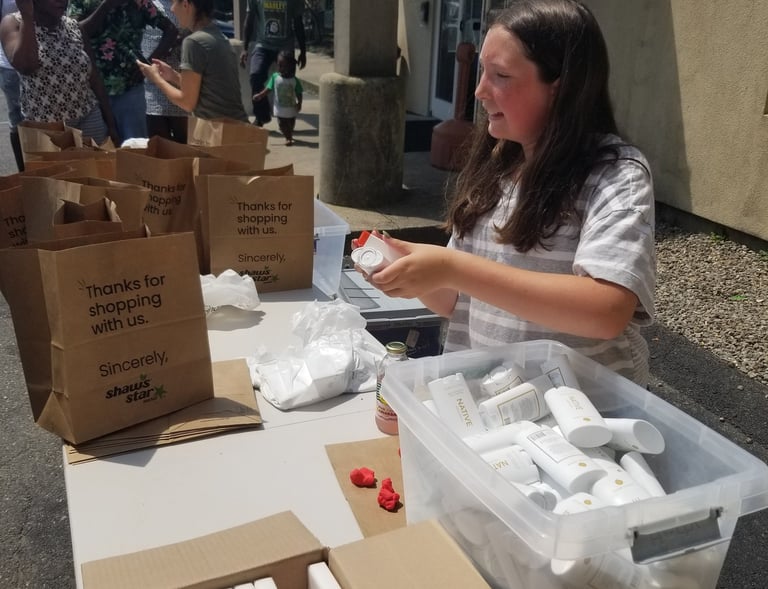 a woman is sitting at a table with boxes of food