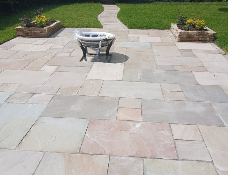 a patio with a table and chairs in the yard