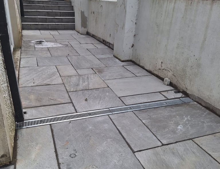 a tiled floor with a drain in the middle of the floor