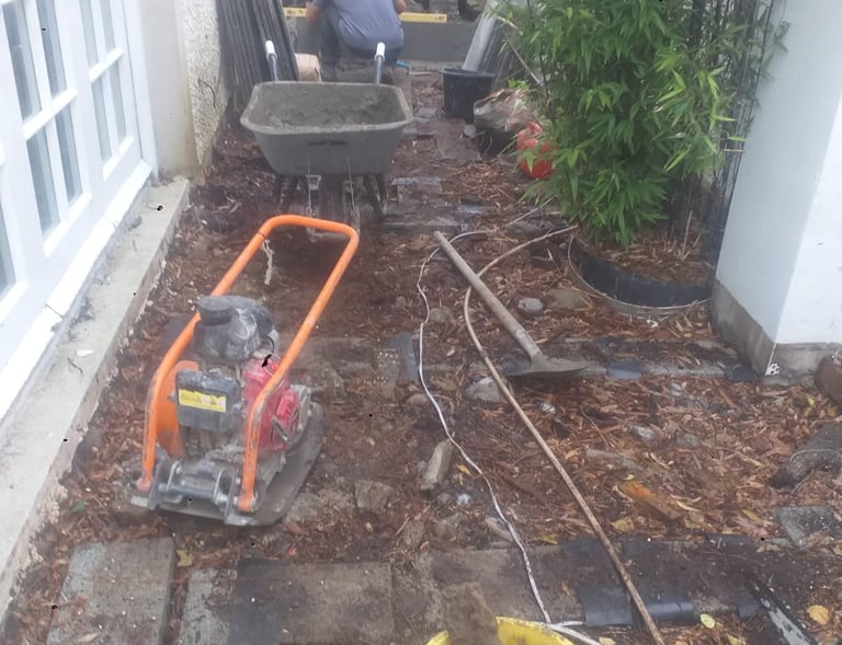 a man is working on a garden with a wheelbar