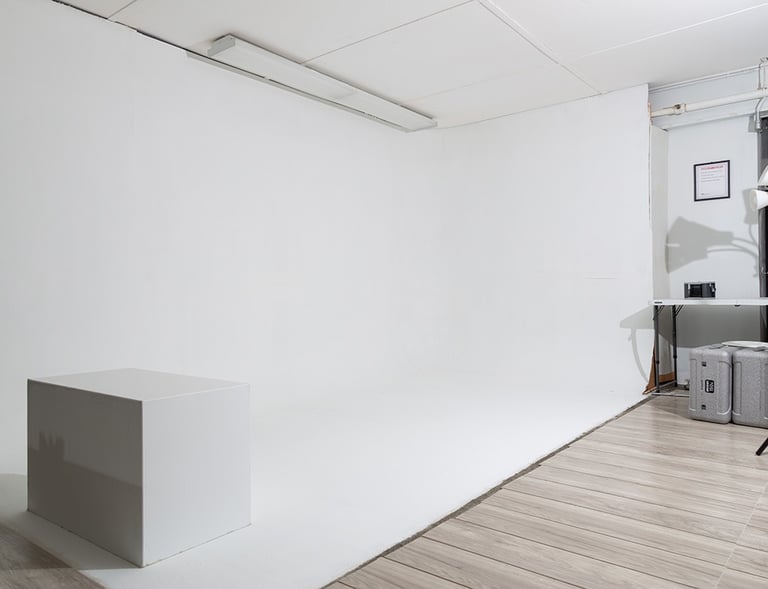a Cyclorama with a white backdrop and a white posing box