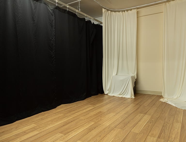 a black curtain in a room with a curtain