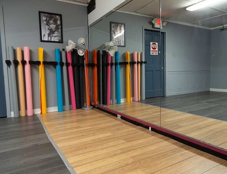 a mirror reflecting a mirror in a room with a row of seamless backdrops