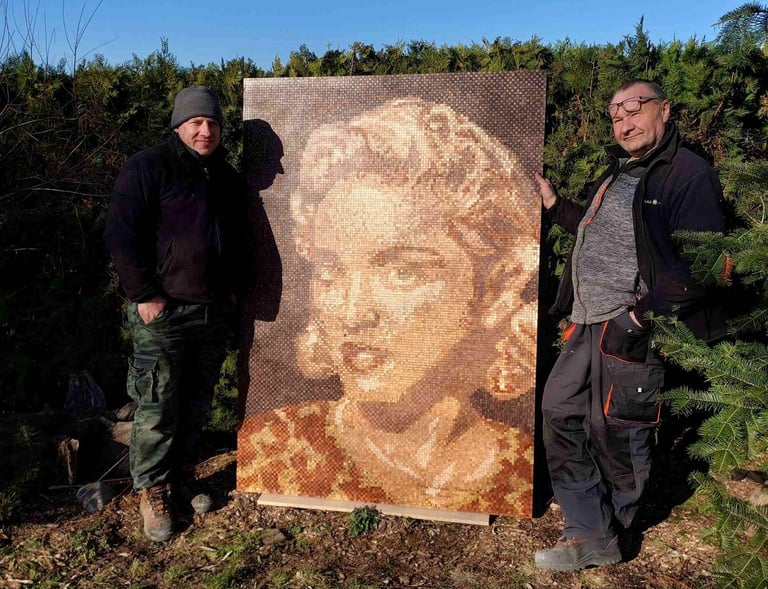 two men standing next to a painting of a woman's face