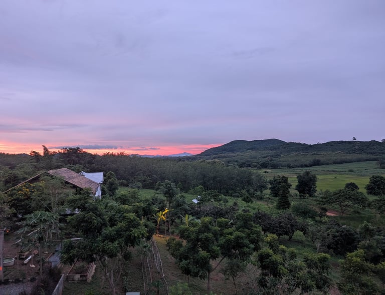 Sunset view across Loei Valley with orchard and foothills in North-Eastern Thailand